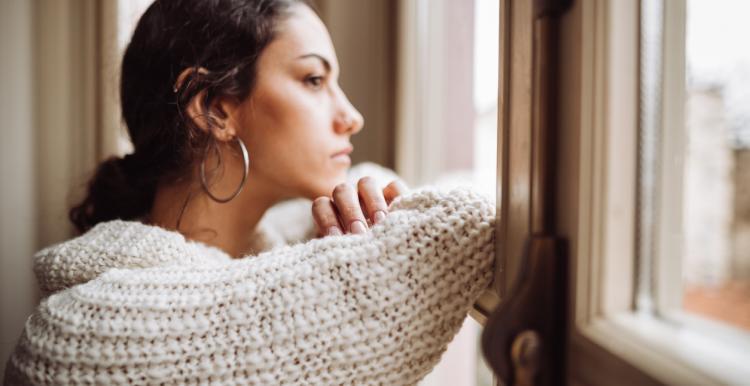 woman looking outside window