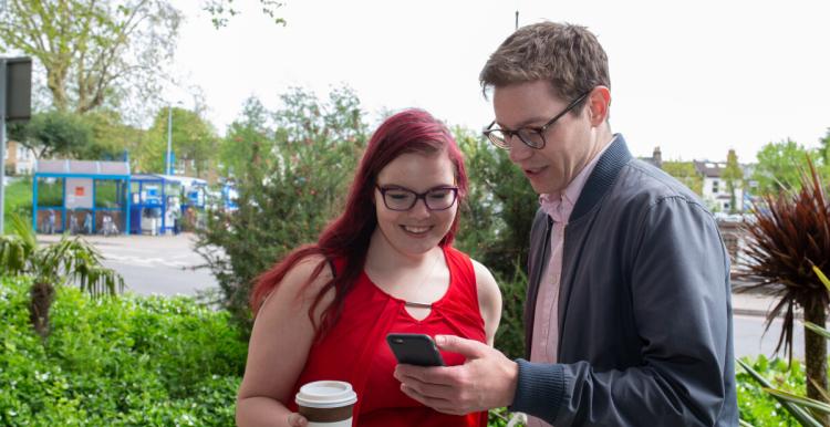 two people looking at a phone